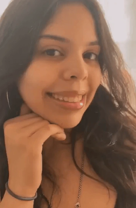 Smiling woman with tooth gem